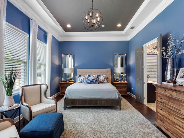 1104 Isobel Reserve Ln, Tampa, FL 33613 - bedroom featuring a raised ceiling, ornamental molding, a chandelier, wood finished floors, and baseboards