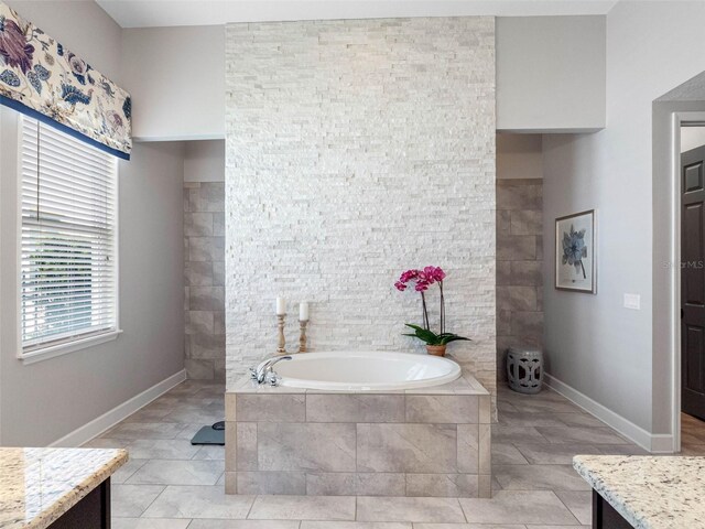 1104 Isobel Reserve Ln, Tampa, FL 33613 - bathroom featuring a bath, vanity, tile patterned floors, and baseboards