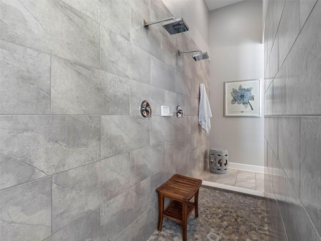 1104 Isobel Reserve Ln, Tampa, FL 33613 - bathroom with a tile shower, baseboards, and tile patterned floors