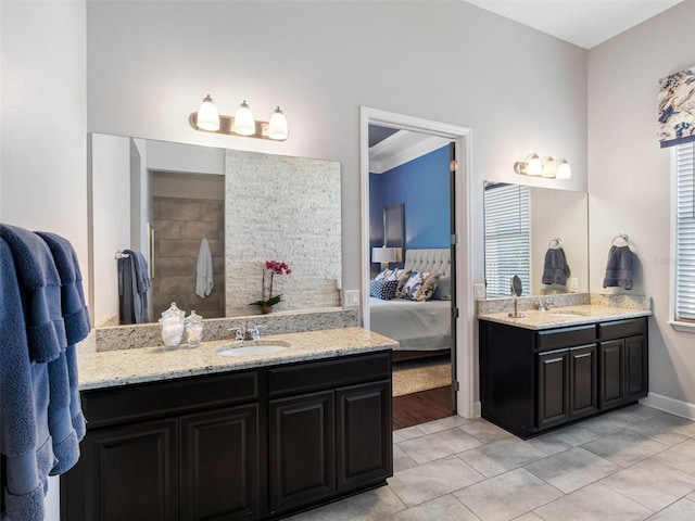 1104 Isobel Reserve Ln, Tampa, FL 33613 - full bathroom with ensuite bath, two vanities, tiled shower, tile patterned floors, and baseboards