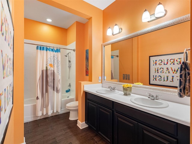 1104 Isobel Reserve Ln, Tampa, FL 33613 - bathroom featuring shower / bath combo with shower curtain, wood finished floors, double vanity, and toilet