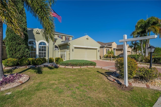 445 Noble Faire Dr, Sun City Center, FL 33573 - view of front of property with stucco siding, a front yard, an attached garage, and driveway