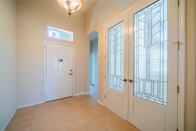 445 Noble Faire Dr, Sun City Center, FL 33573 - entryway with arched walkways, french doors, light tile patterned flooring, and baseboards