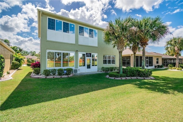 445 Noble Faire Dr, Sun City Center, FL 33573 - back of property with a lawn and stucco siding