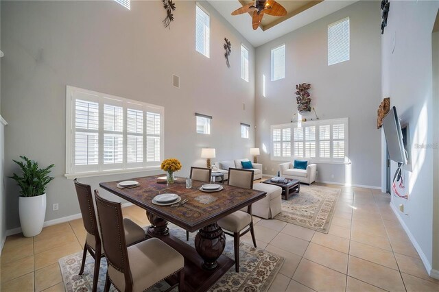 445 Noble Faire Dr, Sun City Center, FL 33573 - dining area featuring a high ceiling, ceiling fan, light tile patterned floors, healthy amount of natural light, and baseboards