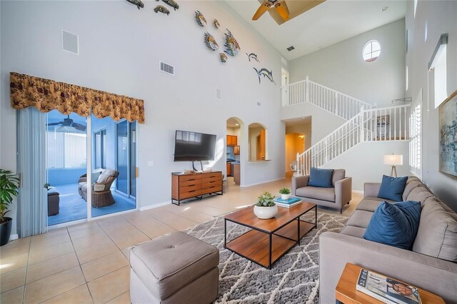 445 Noble Faire Dr, Sun City Center, FL 33573 - tiled living area with a ceiling fan, a high ceiling, stairway, healthy amount of natural light, and arched walkways