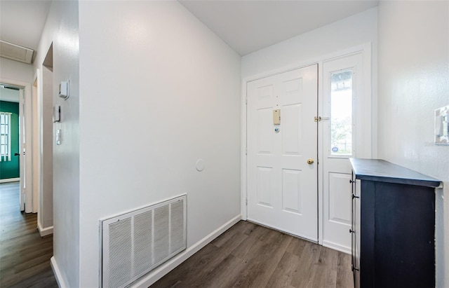 7763 Jenner Ave, New Port Richey, FL 34655 - entrance foyer with dark wood-style flooring, plenty of natural light, and baseboards