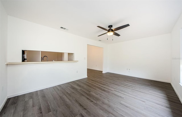 7763 Jenner Ave, New Port Richey, FL 34655 - unfurnished living room with ceiling fan, wood finished floors, and baseboards