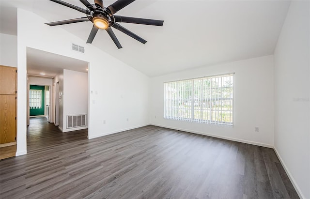 7763 Jenner Ave, New Port Richey, FL 34655 - unfurnished living room with dark wood-style floors, baseboards, ceiling fan, and high vaulted ceiling