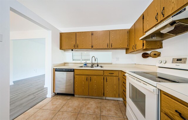 7763 Jenner Ave, New Port Richey, FL 34655 - kitchen featuring white electric range, under cabinet range hood, stainless steel dishwasher, a sink, and brown cabinetry