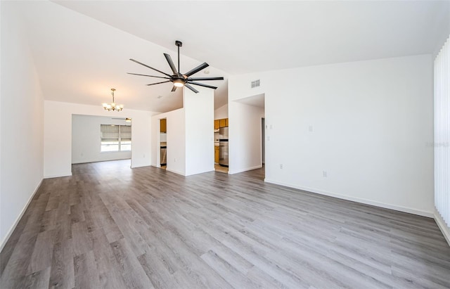 7763 Jenner Ave, New Port Richey, FL 34655 - unfurnished living room with vaulted ceiling, a chandelier, wood finished floors, ceiling fan, and baseboards