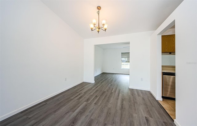 7763 Jenner Ave, New Port Richey, FL 34655 - unfurnished dining area featuring a chandelier, dark wood finished floors, and baseboards