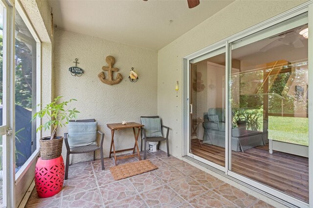 11162 Kapok Grand Cir, Madeira Beach, FL 33708 - sunroom featuring a ceiling fan