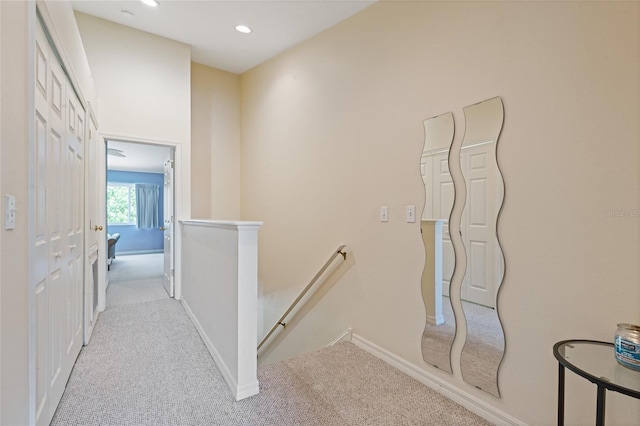11162 Kapok Grand Cir, Madeira Beach, FL 33708 - hall with an upstairs landing, carpet flooring, and recessed lighting