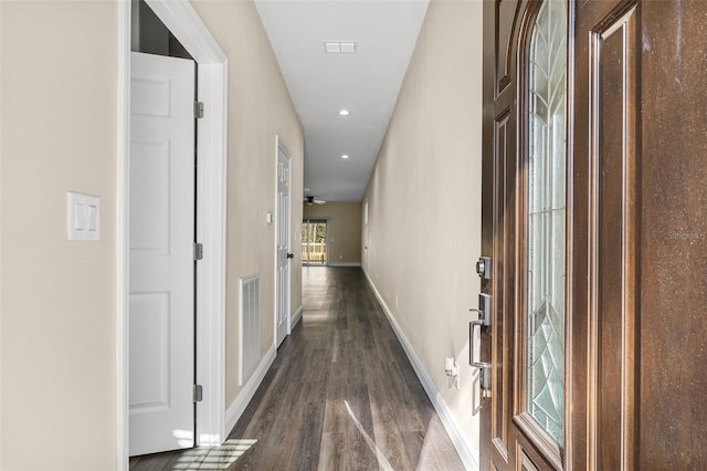 hallway with baseboards, visible vents, recessed lighting, and dark wood-type flooring