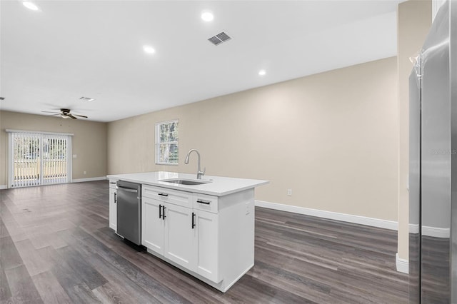 kitchen with a sink, visible vents, an island with sink, open floor plan, and stainless steel dishwasher