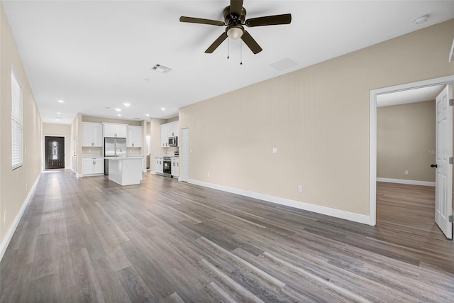 unfurnished living room featuring recessed lighting, baseboards, ceiling fan, visible vents, and wood finished floors