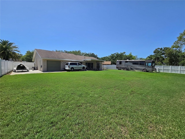 827 Creekside Ln, Palm Harbor, FL 34684 - view of yard with an attached garage and concrete driveway