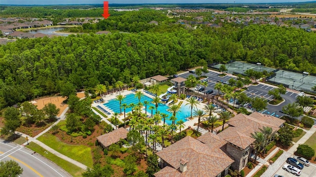 drone / aerial view of a pool and a large body of water
