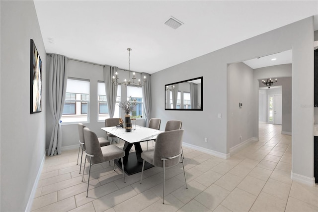 dining space featuring a chandelier, light tile patterned floors, and baseboards