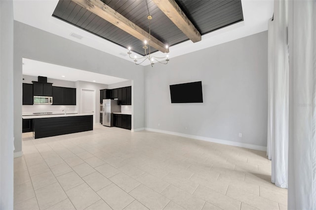 unfurnished living room featuring beamed ceiling, a chandelier, wooden ceiling, light tile patterned floors, and baseboards