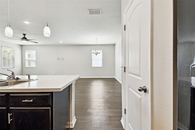 10628 Massimo Dr, Wimauma, FL 33598 - kitchen featuring a sink, light countertops, pendant lighting, a ceiling fan, and open floor plan