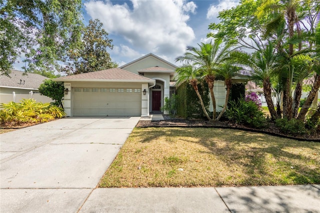 2008 Berry Lake Dr, Brandon, FL 33510 - view of front of home featuring concrete driveway, a garage, stucco siding, and a front yard