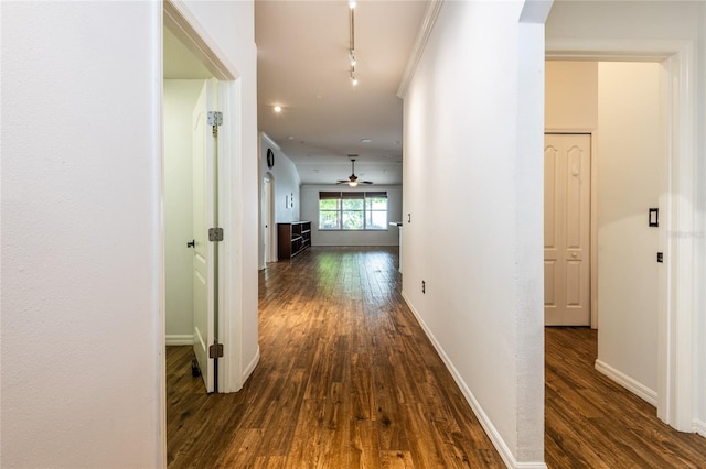 2008 Berry Lake Dr, Brandon, FL 33510 - hallway with track lighting, dark wood-type flooring, baseboards, and arched walkways