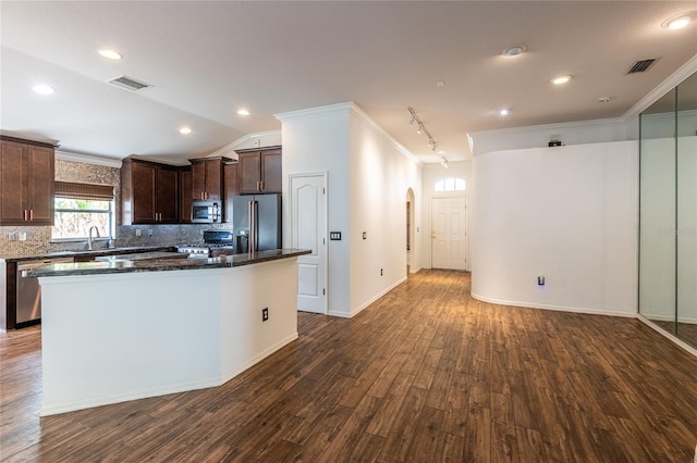 2008 Berry Lake Dr, Brandon, FL 33510 - kitchen with visible vents, dark brown cabinetry, crown molding, arched walkways, and appliances with stainless steel finishes