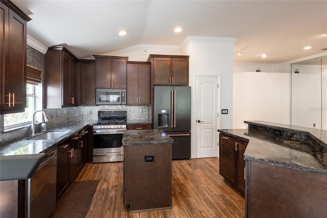 2008 Berry Lake Dr, Brandon, FL 33510 - kitchen featuring a sink, ornamental molding, a kitchen island, and appliances with stainless steel finishes