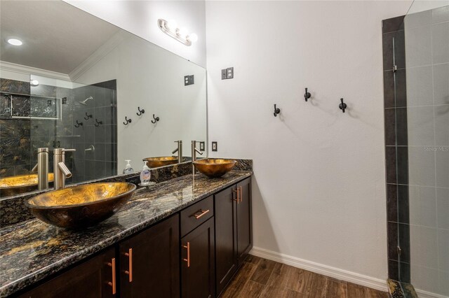 2008 Berry Lake Dr, Brandon, FL 33510 - bathroom featuring a sink, wood finished floors, ornamental molding, a walk in shower, and double vanity