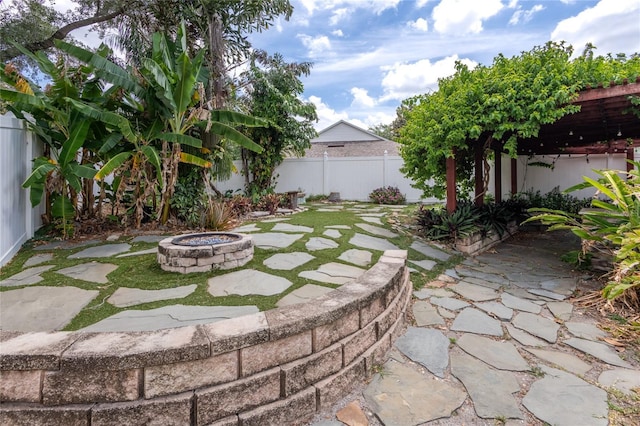 2008 Berry Lake Dr, Brandon, FL 33510 - view of yard featuring an outdoor fire pit, a patio area, and a fenced backyard