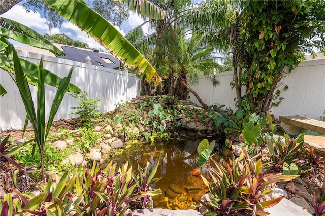2008 Berry Lake Dr, Brandon, FL 33510 - view of yard featuring a small pond and a fenced backyard