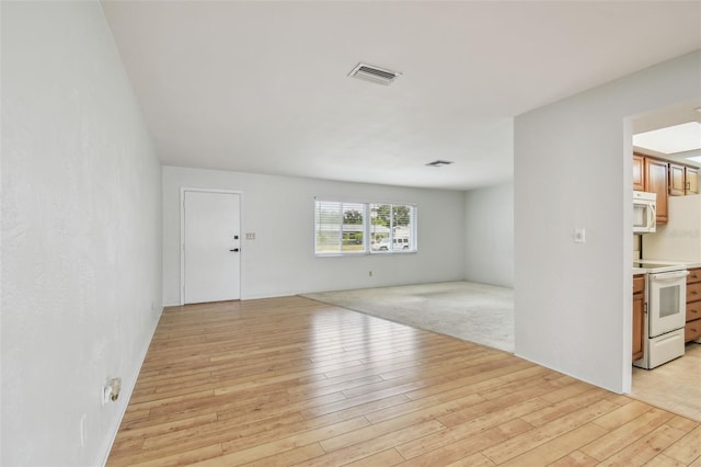 11762 82nd Ter, Seminole, FL 33772 - unfurnished living room with light wood-type flooring