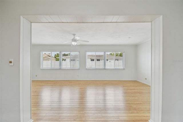 11762 82nd Ter, Seminole, FL 33772 - empty room with wood finished floors, a ceiling fan, and baseboards