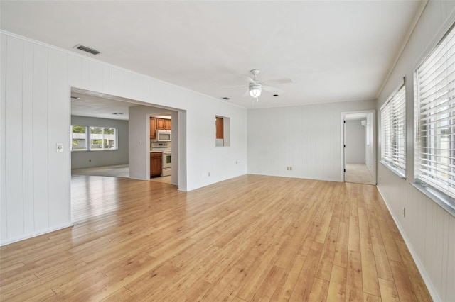 11762 82nd Ter, Seminole, FL 33772 - unfurnished living room with light wood-style floors, a ceiling fan, and ornamental molding