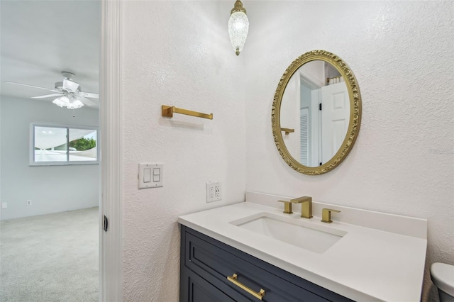 11762 82nd Ter, Seminole, FL 33772 - bathroom featuring a textured wall, vanity, and ceiling fan