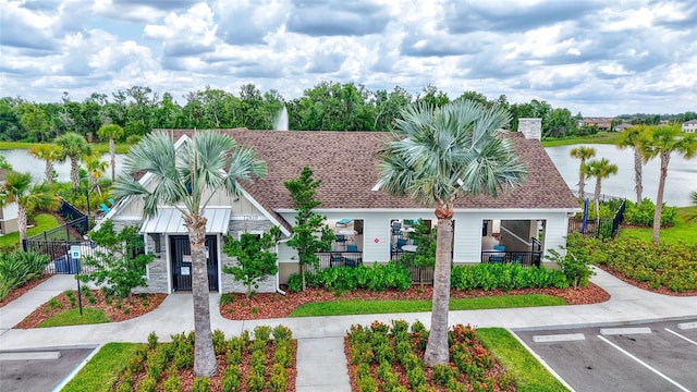 12710 Hysmith Loop, Parrish, FL 34219 - view of property featuring stone siding, uncovered parking, fence, a water view, and a gate