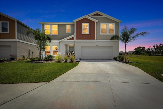 12710 Hysmith Loop, Parrish, FL 34219 - view of front of house featuring an attached garage, concrete driveway, a front lawn, and stucco siding
