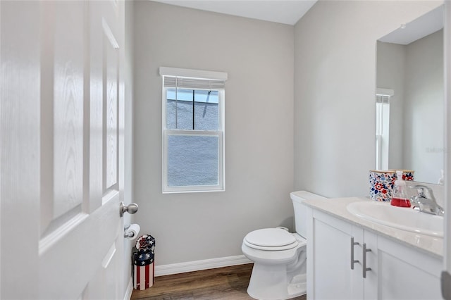 12710 Hysmith Loop, Parrish, FL 34219 - half bathroom with vanity, wood finished floors, toilet, and baseboards