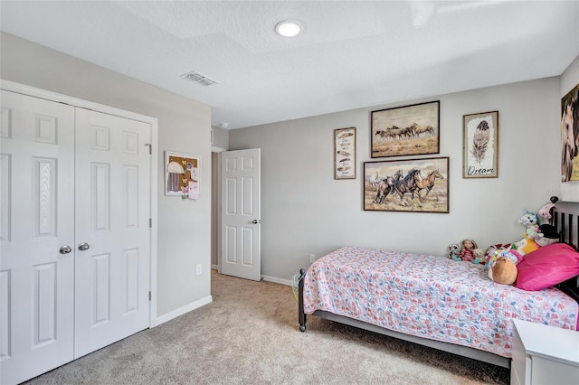 12710 Hysmith Loop, Parrish, FL 34219 - carpeted bedroom featuring baseboards, a textured ceiling, and a closet
