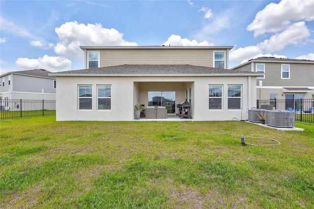 12710 Hysmith Loop, Parrish, FL 34219 - back of property with a shingled roof, a patio, stucco siding, and central AC