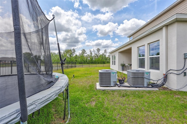 12710 Hysmith Loop, Parrish, FL 34219 - view of yard featuring a trampoline and central air condition unit