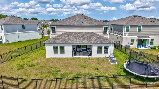 12710 Hysmith Loop, Parrish, FL 34219 - back of house featuring a trampoline, a patio, and roof with shingles