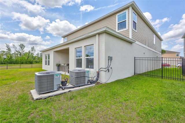 12710 Hysmith Loop, Parrish, FL 34219 - rear view of property featuring central AC unit and stucco siding