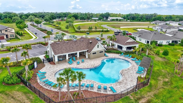 12710 Hysmith Loop, Parrish, FL 34219 - community pool with fence, view of wooded area, a patio area, and a residential view