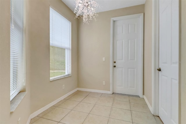 1330 Mariposa Cir Unit 104, Naples, FL 34105 - foyer with light tile patterned floors and a chandelier