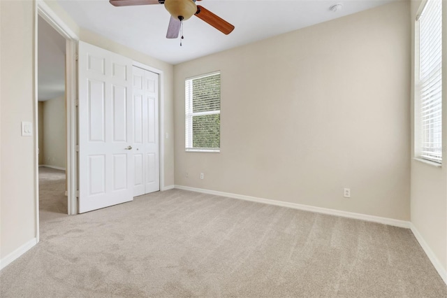 1330 Mariposa Cir Unit 104, Naples, FL 34105 - unfurnished bedroom with carpet flooring, multiple windows, and a closet