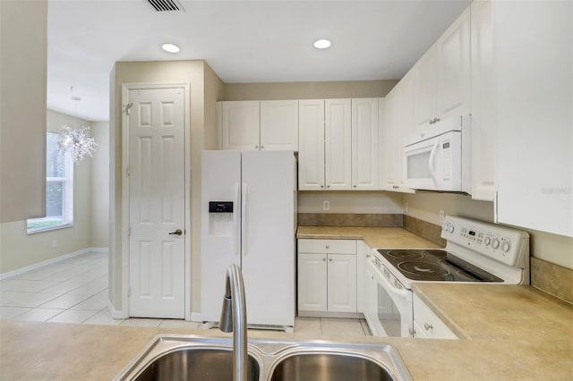 1330 Mariposa Cir Unit 104, Naples, FL 34105 - kitchen featuring white appliances, white cabinetry, light countertops, light tile patterned floors, and recessed lighting