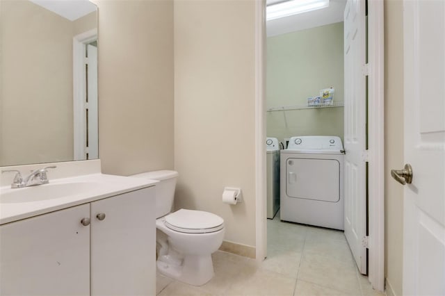 1330 Mariposa Cir Unit 104, Naples, FL 34105 - half bathroom featuring washer and dryer, vanity, and tile patterned floors